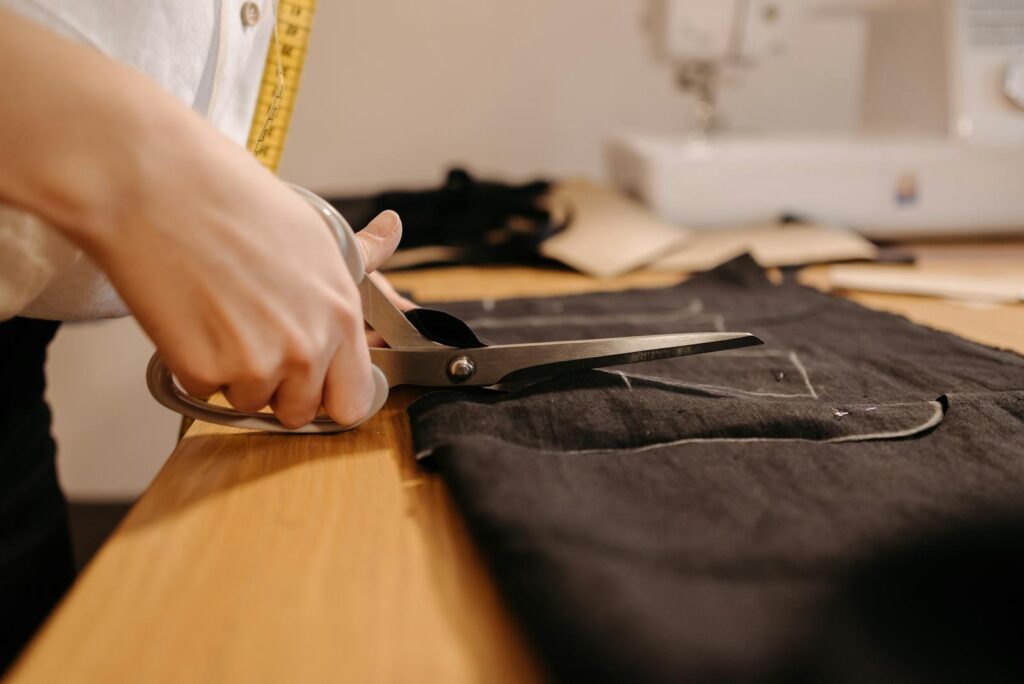 Tailor Cutting a Black Fabric